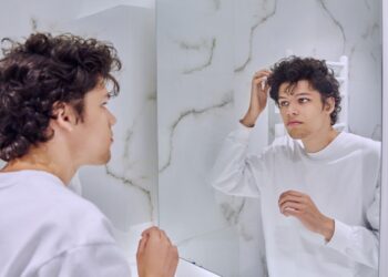 what does it mean when a guy constantly touches himself